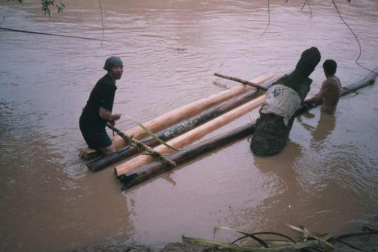 Tim helping lash the logs together with some bark rope we made!